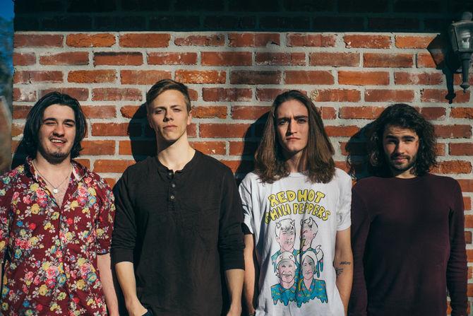 Nice Dog members Austin Roy, Garrett Howell, Logan Wagner, and Robert Denoux stand outside before practicing their new songs on Sunday, March 12, 2017.