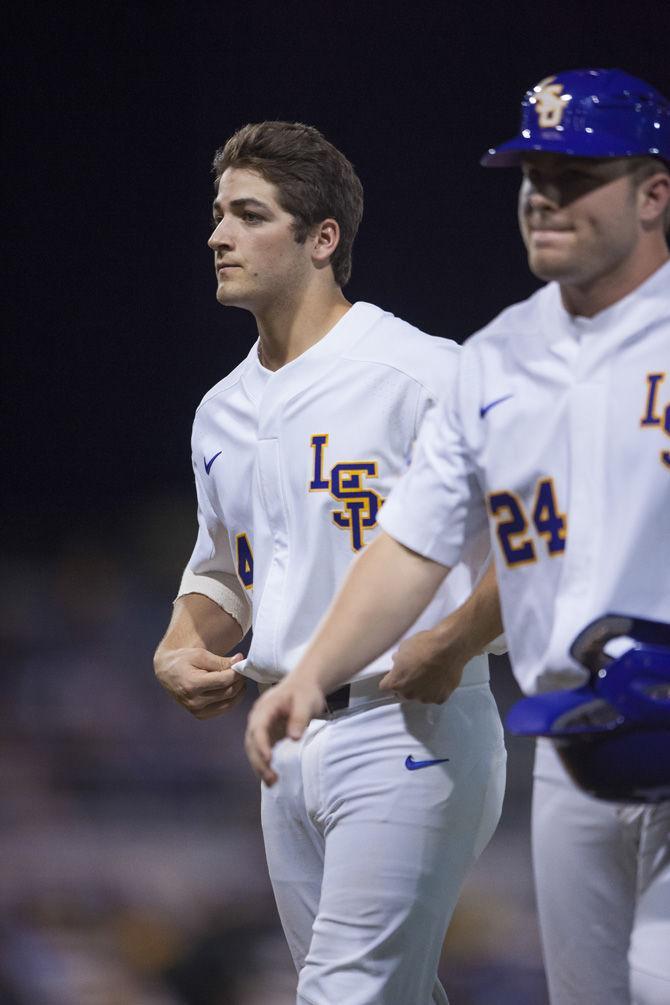 LSU freshman infielder Josh Smith (4) and LSU junior outfielder Beau Jordan (24) walk back to the dugout on Friday, Feb. 24, 2017, during the Tigers 6-1 victory over Maryland at Alex Box Stadium.