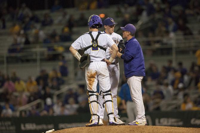 LSU baseball pitching coach Alan Dunn talks to junior catcher Michael Papierski (2) and freshman right-handed pitcher Zack Hess (38) during the Tigers' 8-1 victory against Hofstra on Wednesday, Feb. 22, 2017, at Alex Box Stadium.