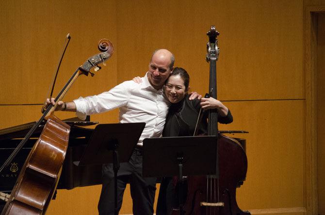 Bass instructor and musician Derek Weller (left) and LSU professor of double bass Yung-chiao Wei (right) hug after their performance at the 2017 Louisiana Bass Fest on Saturday, Feb. 11, 2017, in the LSU School of Music building.