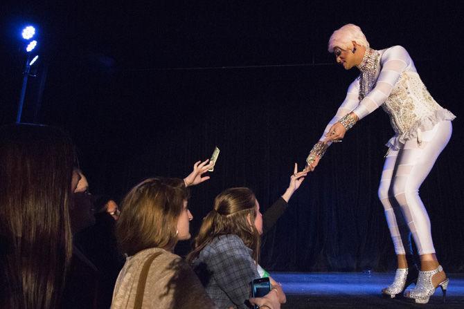 Lady D. Andrews takes a tip from a fan during her performance on Saturday, March 4, 2017 in the Student Union.