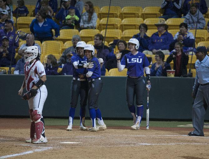 LSU senior outfielder Bailey Landry (26) (left), senior catcher and infielder Sahvanna Jaquish (2) and freshman infielder Sydney Springfield (15) celebrate during the Tigers&#8217; 10-2 victory over ISU on Friday, March 3, 2017, at Tiger Park.