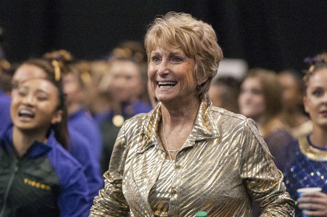 LSU coach D-D Breaux celebrates during the Tigers' first place win in the NCAA Semifinals Session II with a 198.275 team score to advance to the Super Six Championship on Friday, April 14, 2016 in the Chaifetz Arena, in St. Louis, Missouri.