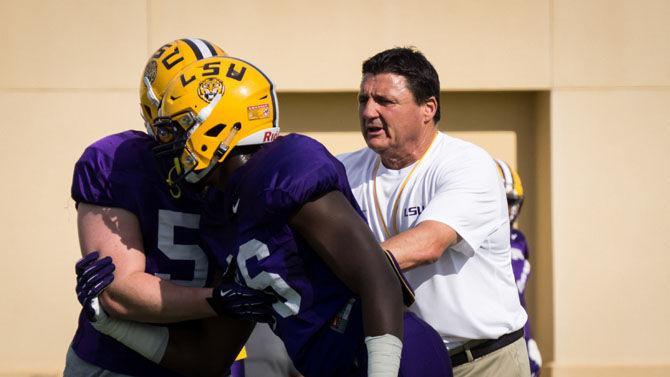 LSU football coach Ed Orgeron works with defensive lineman during spring football practice on Tuesday, April 4, 2017, at the Charles McClendon LSU football practice facility.