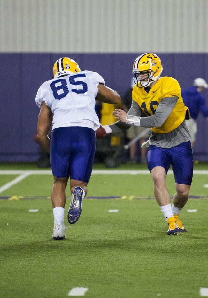 LSU senior quarterback Danny Etling (16) hands off the ball to sophomore tight end Caleb Robby (85) during the first spring football practice on Thursday, March 30, 2017 at the Charles McClendon LSU football practice facility.