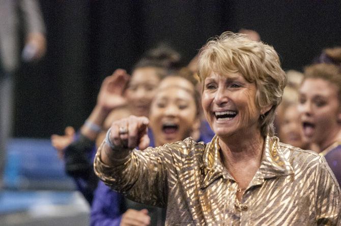 LSU coach D-D Breaux celebrates during the Tigers' first place win in the NCAA Semifinals Session II with a 198.275 team score to advance to the Super Six Championship on Friday, April 14, 2016 in the Chaifetz Arena, in St. Louis, Missouri.