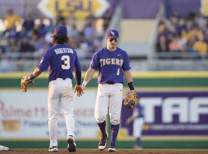 LSU senior infielders Kramer Robertson (3) and Cole Freeman (8) shake hands after a double play during the Tigers' 5-1 win against the University of Georgia on Saturday, March 18, 2017 at Alex Box Stadium.