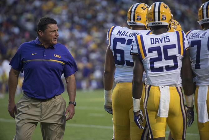 LSU coach Ed Orgeron speaks to players as he heads toward the sideline during the Tigers' spring game on Saturday, April 22, 2017 at Tiger Stadium.