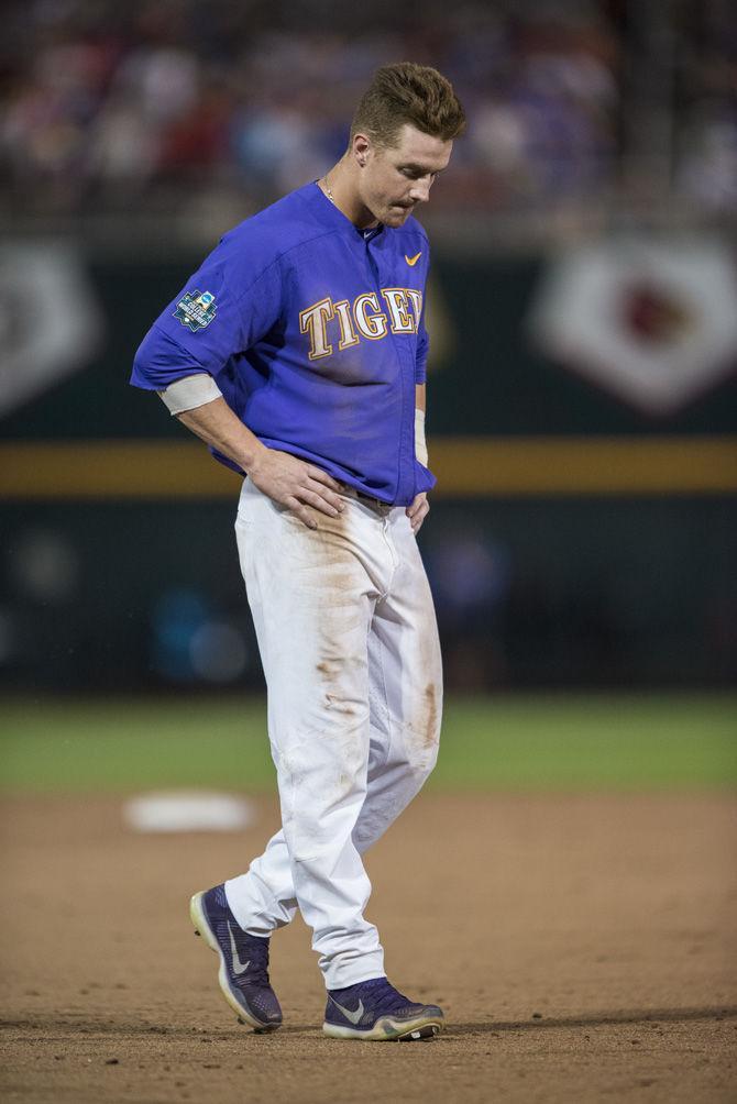 LSU junior infielder Greg Deichmann (7) walks off the field after getting out on first during the Tigers' 6-1 loss against Florida on Tuesday June 27, 2017, at TD Ameritrade Park in Omaha, Nebraska.