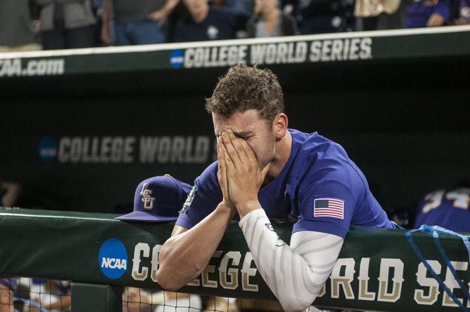 Junior pitcher Alex Lange puts his face in his hands as the Florida Gators win the College World Series national championship on June 27, 2017 at TD Ameritrade Park in Omaha, Nebraska.&#160;