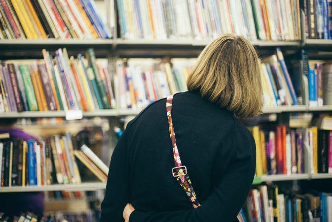 An attendee looking through books during the last day of the Friends of the LSU Libraries Annual Book Bazaar on Saturday, March 11, 2017 in the 4-H Mini Barn.