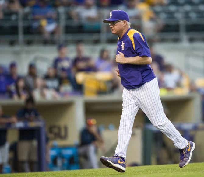 LSU baseball head coach Paul Mainieri runs off the field after a pitcher change during the Tigers 7-6 loss against the University of South Alabama on Tuesday May 9, 2017, in Alex Box Stadium.