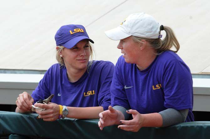 <p>Then-players Dylan Supak (11) and Kailey McCasland Carlock (33) in the dugout on March 25, 2015 at Tiger Park.</p>