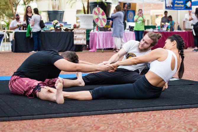 [From left to right] Alan Rada, Gorgan Jagetic and Chiye Fox from "Acro Rouge!" begin to stretch before beginning their interactive yoga session at the sixth annual Peace Fest at the Belle of Baton Rouge Casino and Hotel on Saturday June 3, 2017.