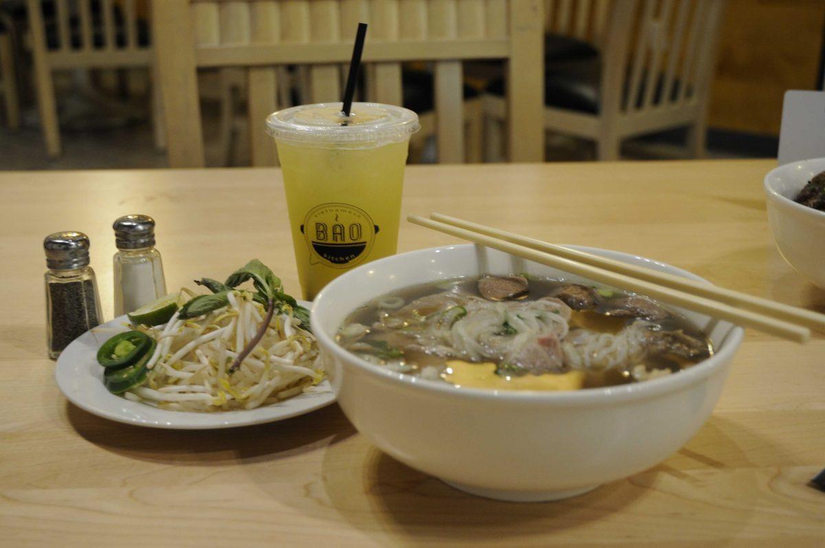 A bowl of combination pho sits with with sugercane juice and a side of vegetables at Bao Vietnamese Kitchen at 8342 Perkins Road&#160;on July 1.&#160;