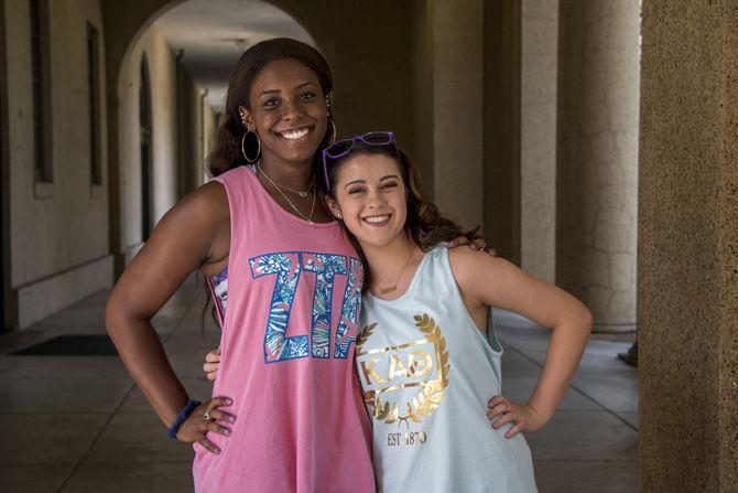 LSU history Pre-Med senior Kourtney Khalid-Abasi, left, (Zeta Tau Alpha) and LSU english sophomore Molly Holmes, right, (Kappa Alpha Theta) represent their sororities with corresponding tank-tops outside of Audubon Hall on Aug. 21, 2017 at LSU.