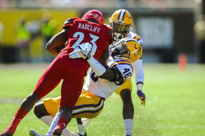 LSU junior linebacker Donnie Alexander (48) attempts to drag down Louisville senior running back Brandon Radcliff (23) on Saturday, Dec. 31, 2016, during the Tigers' 29-9 Buffalo Wild Wings Citrus Bowl win against the Cardinals at Camping World Stadium in Florida.