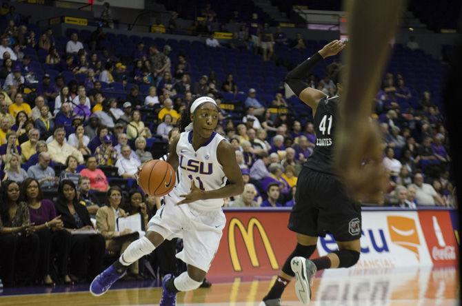 LSU junior guard Raigyne Moncrief (11) dribbles around South Carolina player during the Lady Tigers' 84-61 loss against the University of South Carolina on Sunday, Jan. 15, 2017, in the PMAC.