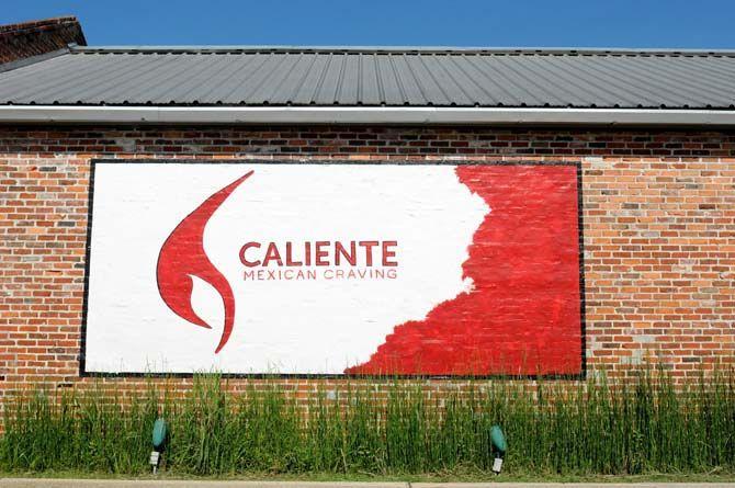 Caliente Mexican Craving on W. Lee Drive is one of a small number of businesses to keep up the old tradition of hand painting signs.