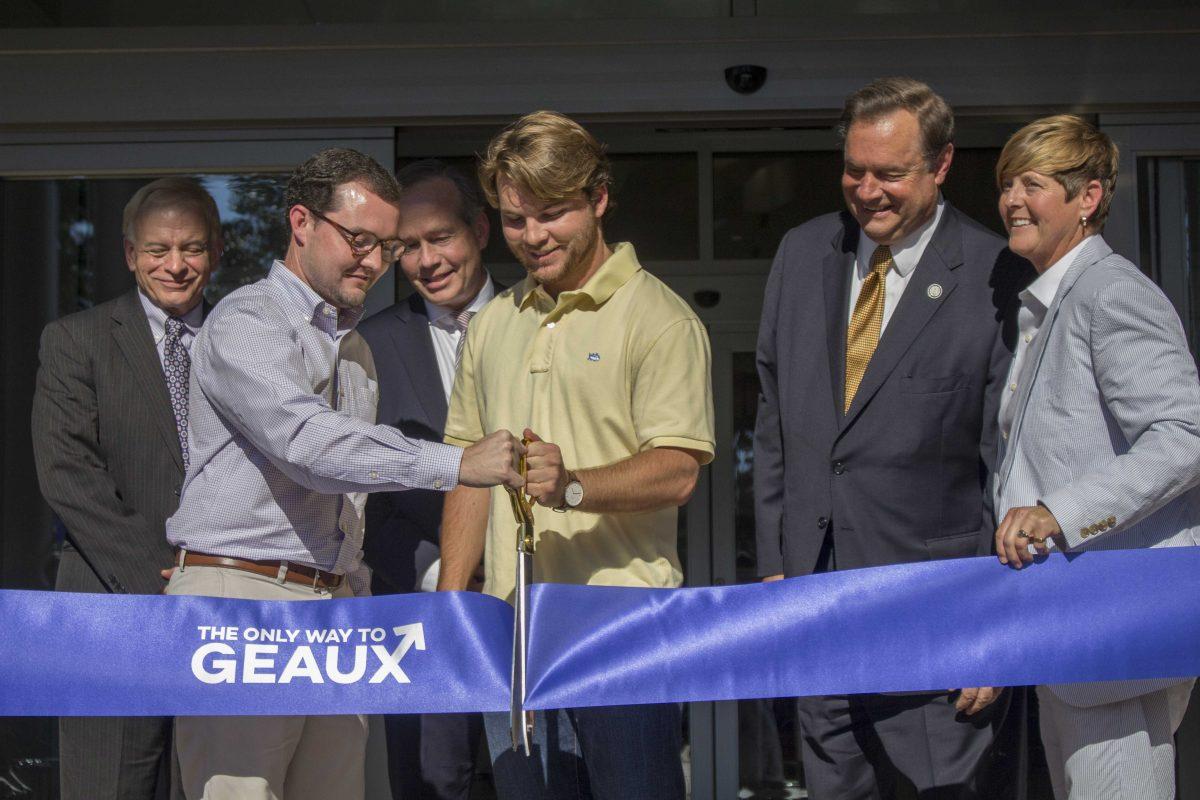 LSU faculty watch as 2017 LSU Student Government president Jason Badeaux and 2011 Student Government president Cody Wells, who initiated the plans to renovate the UREC, cut the ribbon at the UREC's Grand Opening Ceremony on Sept. 8, 2017.