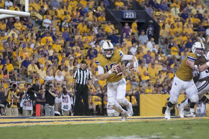 LSU junior quarterback Danny Etling (16) scrambles on Saturday Sept. 17, 2016, during the Tigers' 23-20 victory over the Mississippi State Bulldogs.