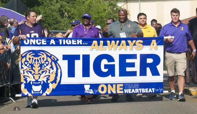 LSU alumni walk to Tiger Stadium before the LSU v Chattanooga game on Saturday, Sept. 9, 2017, on North Stadium Drive.