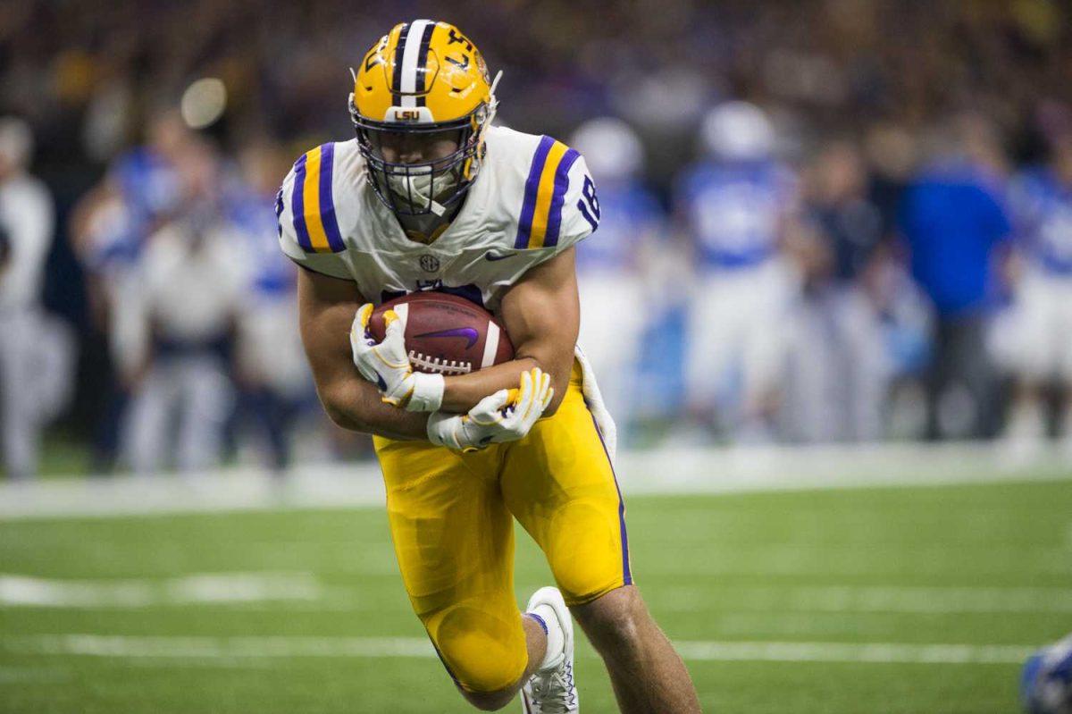 LSU senior tight-end J.D. Moore (18) runs downfield with the ball during LSU's 27-0 win against BYU on Saturday, Sept. 2, 2017, at the Mercedes-Benz Superdome in New Orleans.