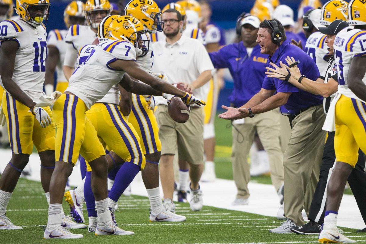 LSU head football coach Ed Orgeron celebrates with senior wide-receiver D.J. Chark (7) after punt return on the LSU side-line during LSU's 27-0 win against BYU on Saturday, Sept. 2, 2017, at the Mercedes-Benz Superdome in New Orleans.