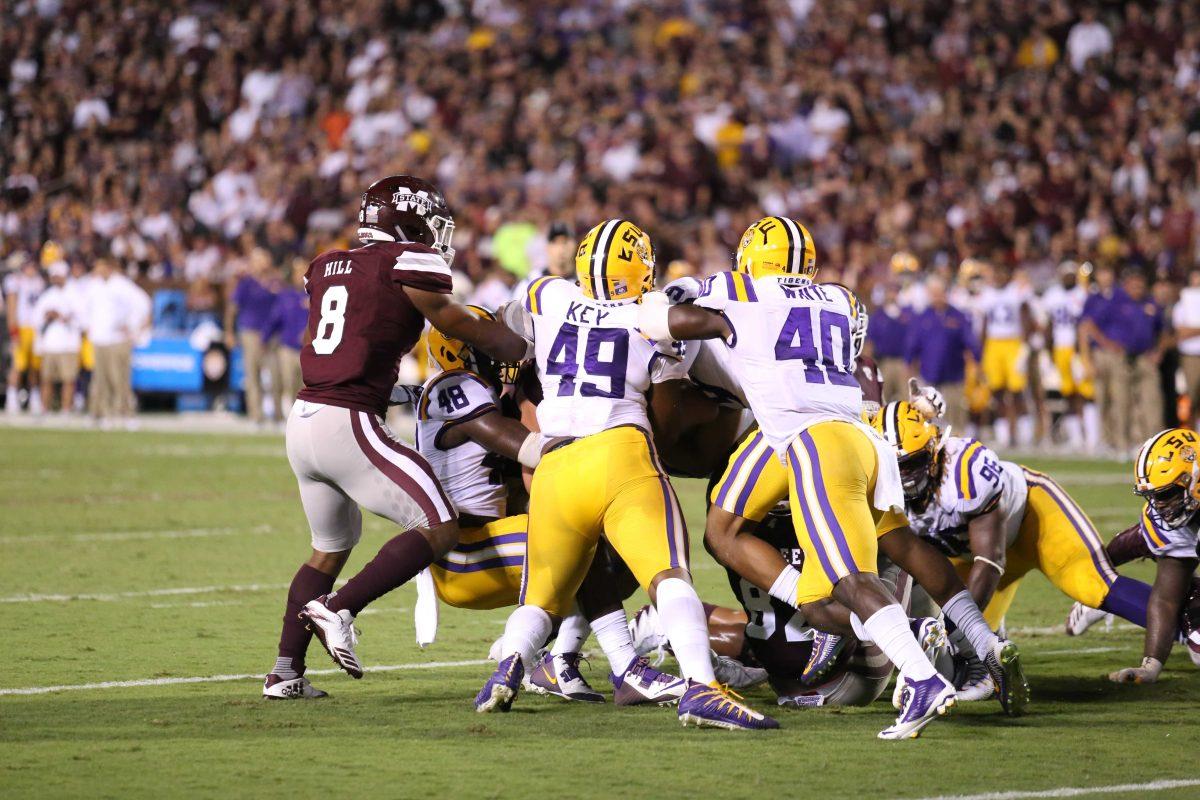 LSU junior edge rusher Arden Key (49) and sophomore linebacker Devin White (40) hold Mississippi State's offense back during LSU's 37-7 loss against Mississippi State at Davis Wade Stadium on Sept. 16, 2017.