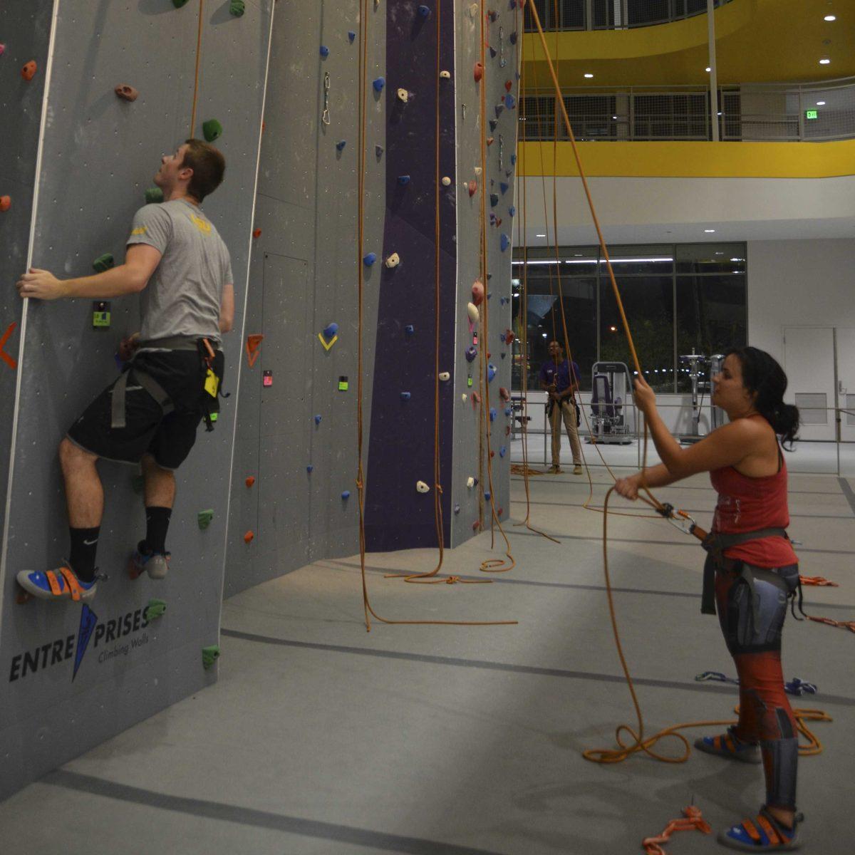 LSU veterinary senior Sofia Raldiris holds the ropes for LSU medical physics graduate student Andrew Mcguffey as he participates in rock climbing in the UREC on Friday, Sept. 22, 2017.