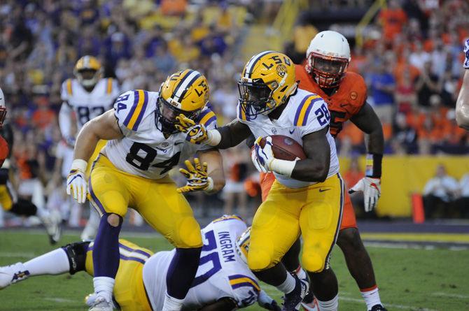 LSU senior running back Darrel Williams (28) runs down the field with the ball and LSU junior tight end Foster Moreau (84) during the Tigers' 35-26 win against Syracuse on Saturday, Sept. 23, 2017.