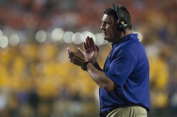 LSU football coach Ed Orgeron applauds the team during the Tigers' 35-26 victory against Syracuse on Saturday, Sept. 23, 2017, in Tiger Stadium.