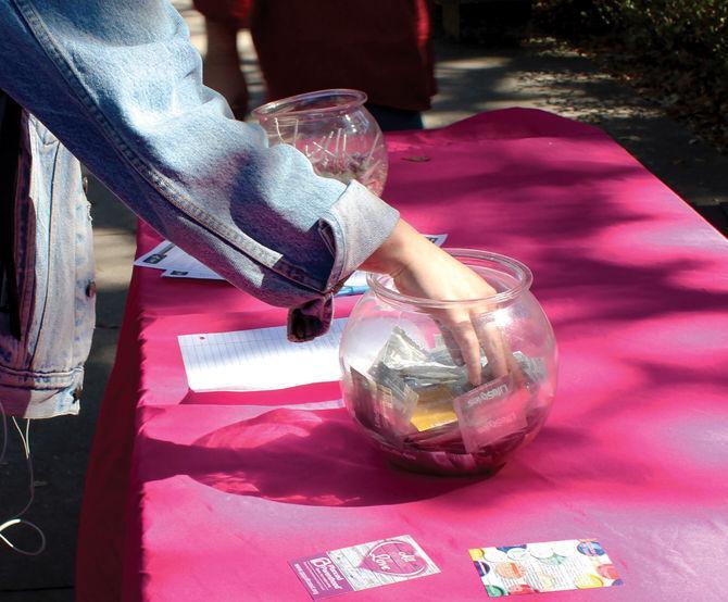 A student takes a condom from the Planned Parenthood table Feb. 10, 2017 during Free Condom Friday in Free Speech Plaza.&#160;