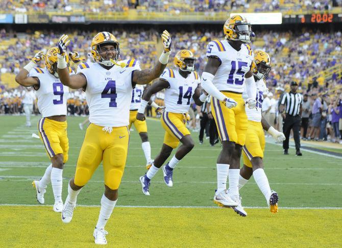 The LSU football players pump up the crowd before the Tigers' 35-26 victory against Syracuse on Saturday, Sept. 23, 2017, in Tiger Stadium.