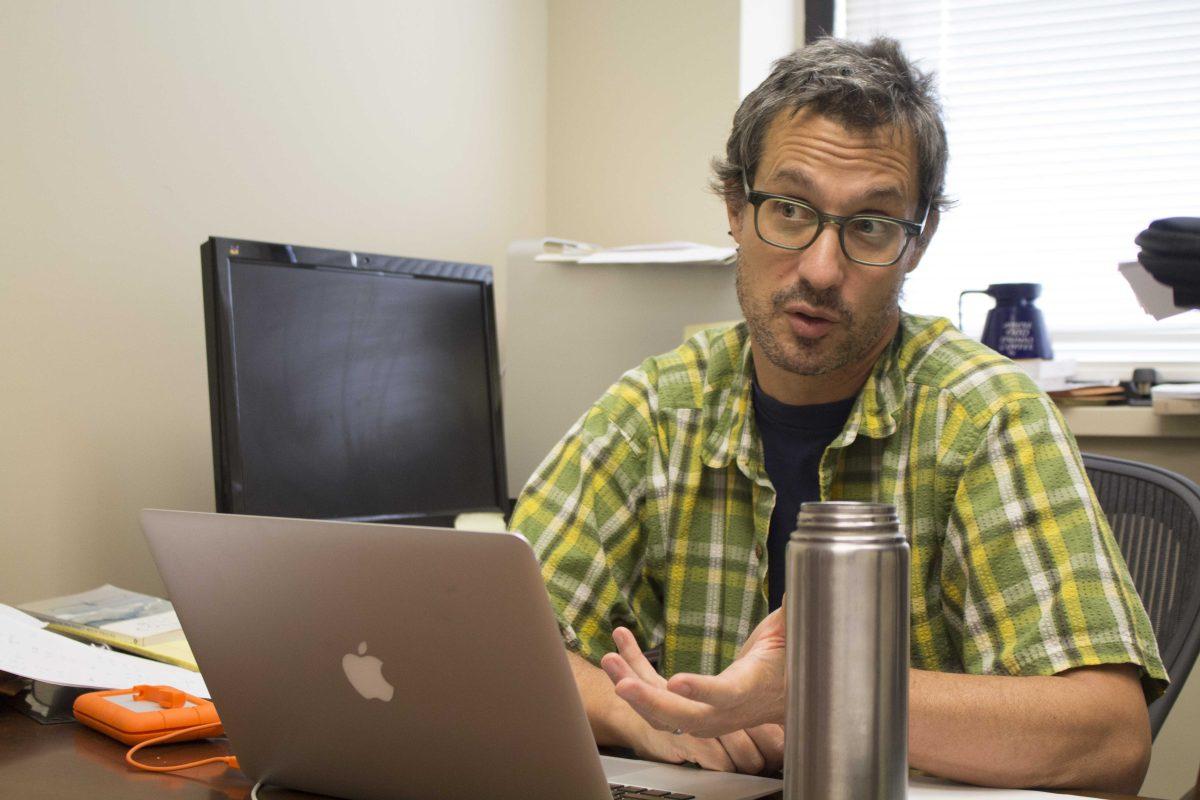 University professor Bret D. Elderd speaks about his research involving insects that stop the spread of disease through cannibalism at the University&#8217;s Life Sciences Annex on Friday, Oct. 13, 2017.