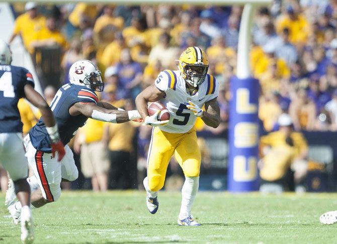 LSU junior running back Derrius Guice (5) runs the ball during Auburn's 23-14 lead against LSU at halftime on Saturday, Oct. 14, 2017, in Tiger Stadium.