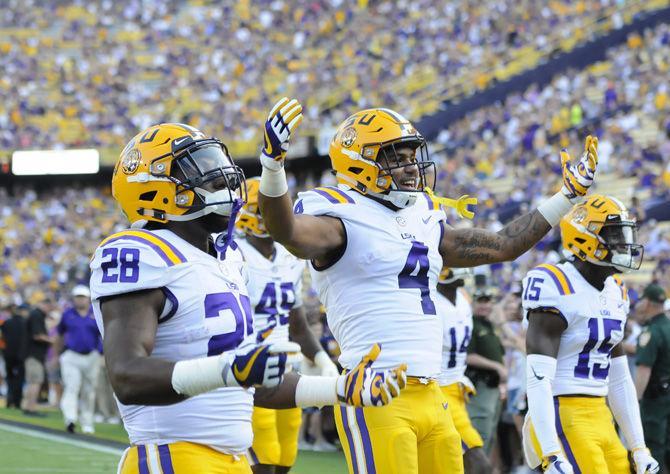 The LSU football players pump up the crowd before the Tigers' 35-26 victory against Syracuse on Saturday, Sept. 23, 2017, in Tiger Stadium.