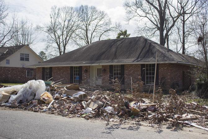 Debris sits on the lawn of a house in Sherwood Forest on Saturday, Feb. 11, 2017, on Woodcliff Drive in Baton Rouge, Louisiana.