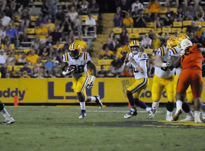 LSU senior running back Darrel Williams (28) runs the ball during the Tigers' 35-26 victory against Syracuse on Saturday, Sept. 23, 2017, in Tiger Stadium.