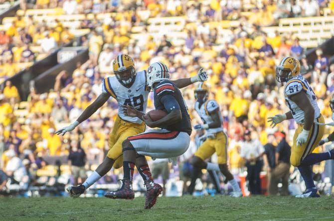 LSU freshman defensive end Arden Key (49) tackles junior quarterback Jeremy Johnson (6) during the Tigers' 45-21 victory against Auburn on Saturday, Sept.19, 2015, in Tiger Stadium.