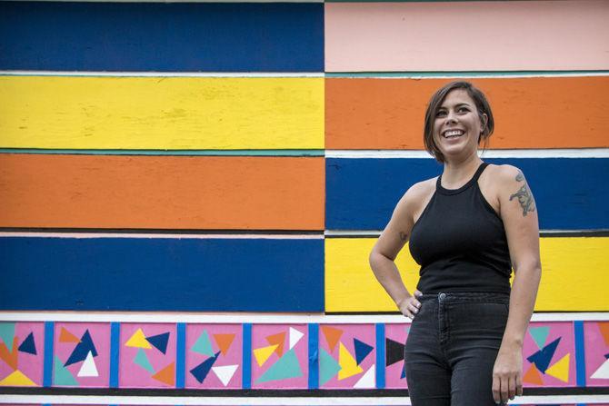 LSU alumna Stephanie Landry stands in front of her mural on Sunday, Oct. 22, 2017 at Mid City Redevelopment Alliance on the corner of Laurel Street and N 19th Street.