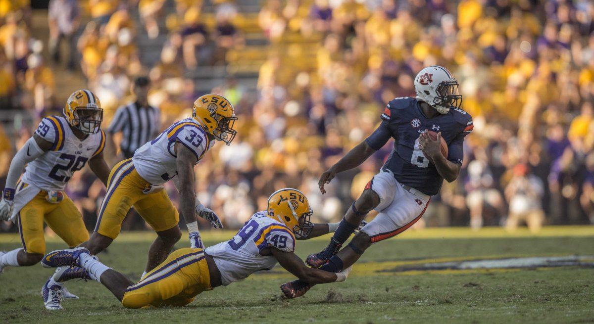 LSU defensive end freshman Arden Key (49) tackles junior quarterback Jeremy Johnson (6) during the Tigers' 45-21 victory against Auburn on Saturday, Sept. 19, 2015 in Tiger Stadium