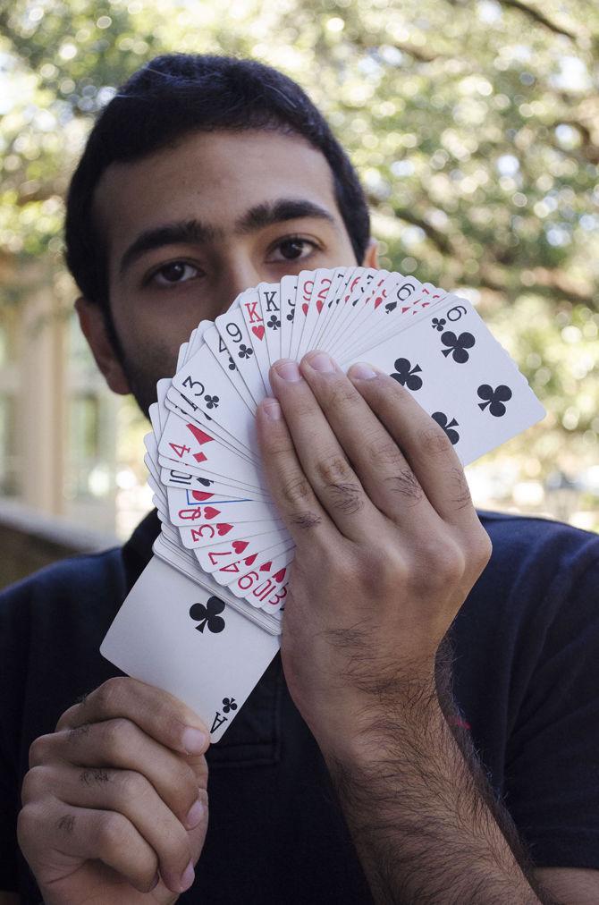 Petroleum engineering senior Abdulaziz M Aljazaf&#160;performs card tricks with the LSU Magic Club on Tuesday, Oct. 17, 2017, outside the LSU Student Union.