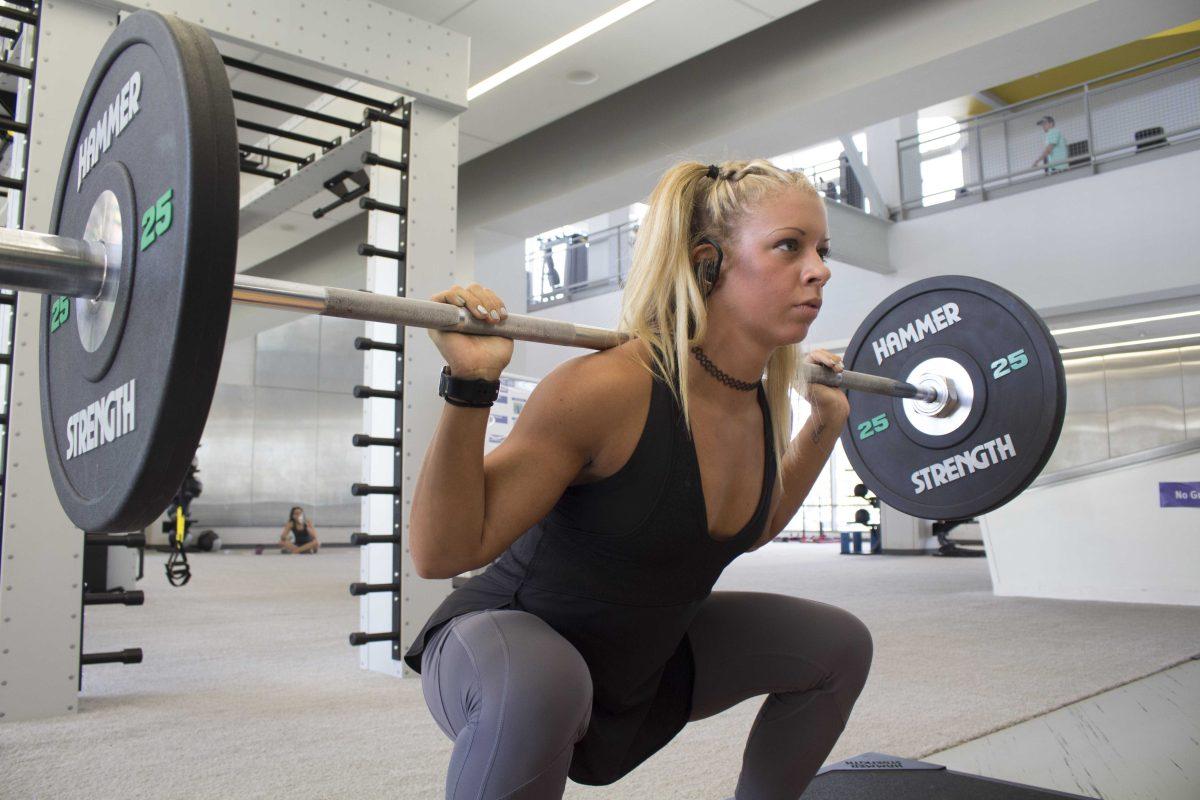 Kinesiology senior and bodybuilder Victoria Schlumbrecht lifts weights at the UREC on Sept. 25, 2017.