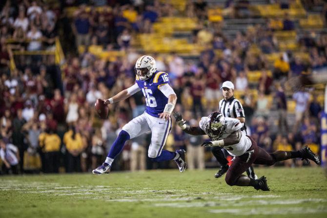 LSU senior quarterback Danny Etling (16) runs with the ball in hand during the Tigers' 24-21 loss against Troy in Tiger Stadium on Saturday, Sept. 30, 2017.