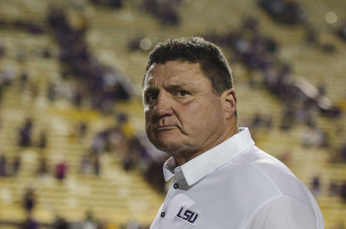 Coach Orgeron exits the stadium sadly during the Tigers' 24-21 loss against Troy in Tiger Stadium on Saturday, Sept. 30, 2017.