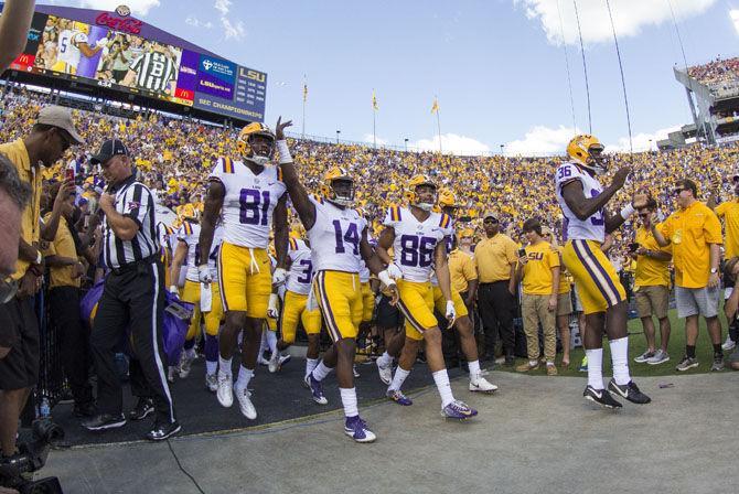 The LSU football team runs onto the field before the Tigers' 27-23 victory against Auburn on Saturday, Oct. 14, 2017, in Tiger Stadium.