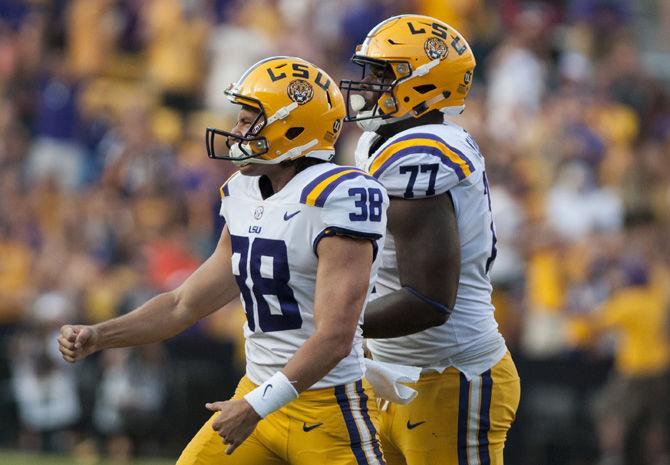 LSU sophomore punter Josh Growden (38) and freshman offensive lineman Saahdiq Charles (77) celebrate during LSU's 27-23 victory against Auburn on Saturday, Oct. 14, 2017 at Tiger Stadium.