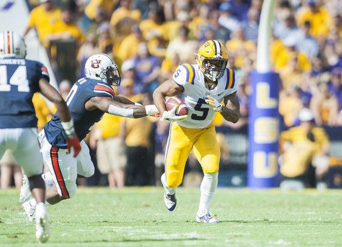 LSU junior running back Derrius Guice (5) runs the ball during the Tigers' 27-23 victory against Auburn on Saturday, Oct. 14, 2017, in Tiger Stadium.