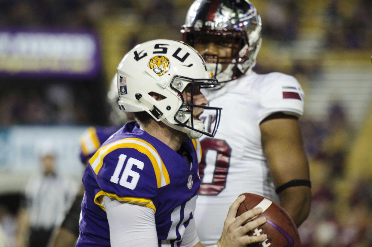 LSU senior quarterback Danny Etling (16) runs with the ball during the Tigers' 24-21 loss against Troy in Tiger Stadium on Saturday, Sept. 30, 2017.